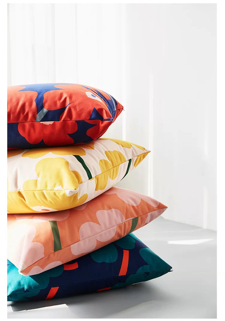 Stack of colorful pillows on a white surface