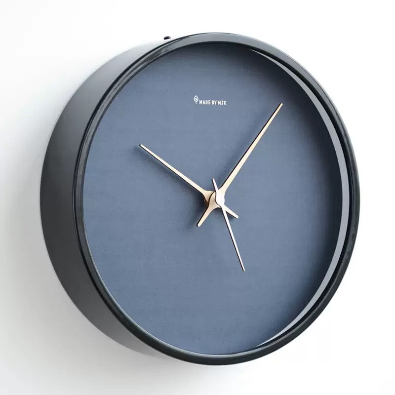 Wall clock with dark face and black frame on a white background