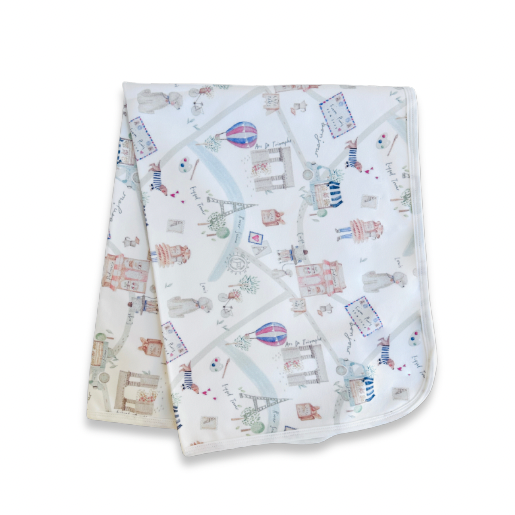 Baby blanket with travel-themed design on a white background