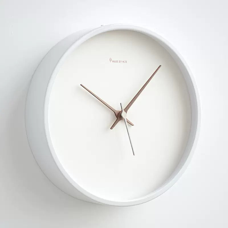 White wall clock with wooden hands on a white background