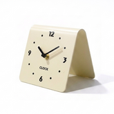Minimal matte metal desk clock with a folded stand design on a white background