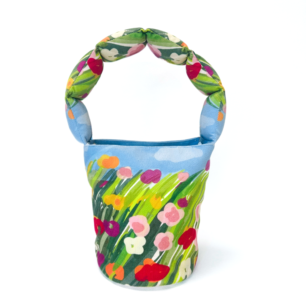 Colorful floral-patterned bag with a sky design on a white background