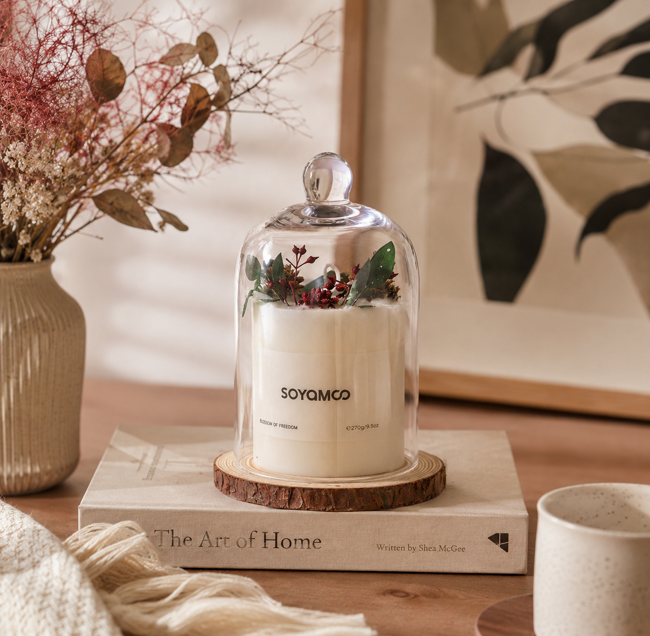 Glass cloche soy candle displayed on a coffee table