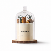 Decorative soy candle with glass cloche and wooden base